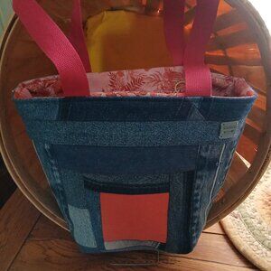 DENIM RECYCLED INTO TOTE WITH ZIPPER ON TOP.  PINK AND FADED BLUE DENIM.